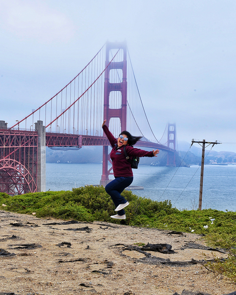 Angelica jumping in front of the golden gate bridge.