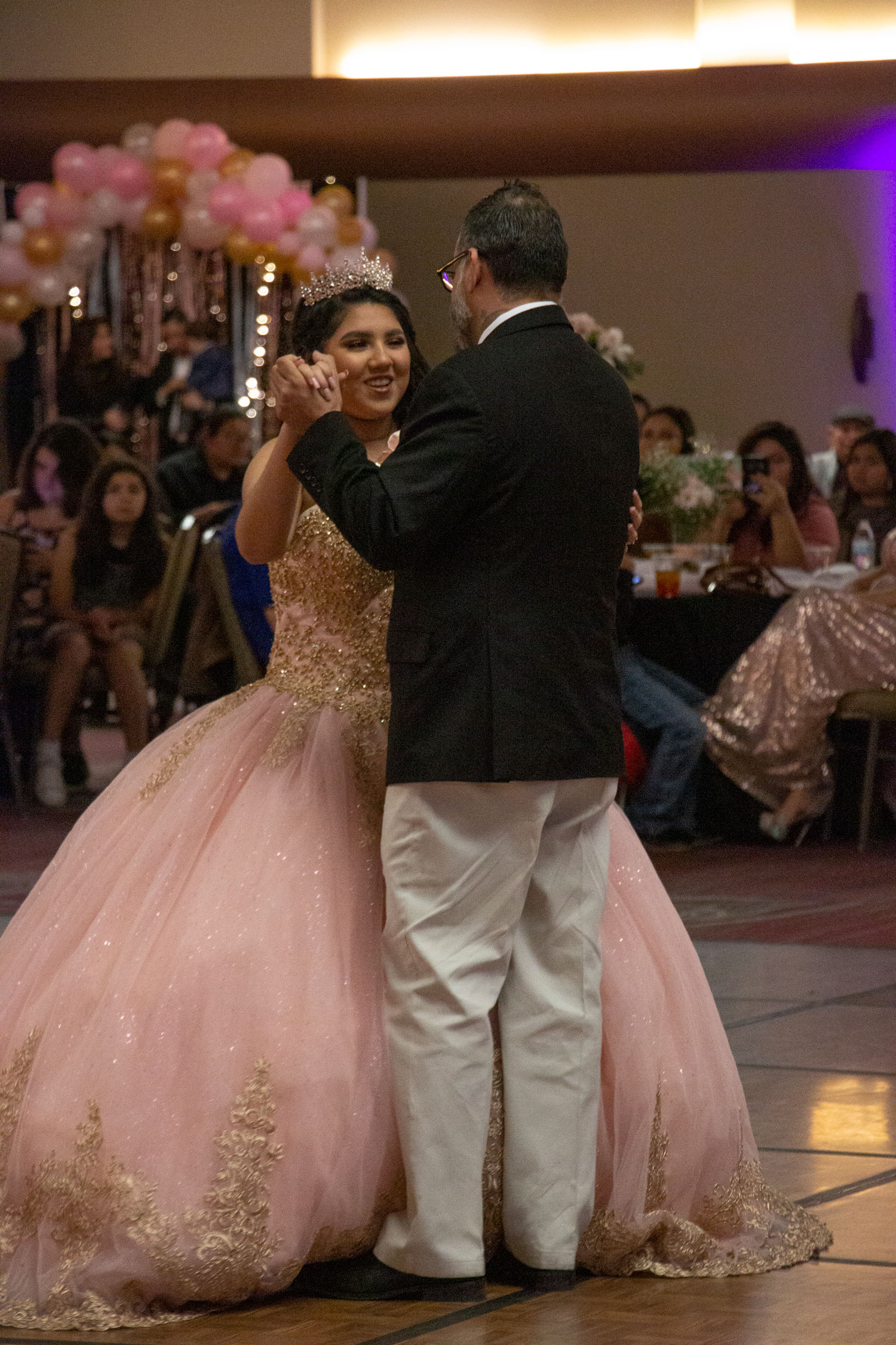 MeLeigha dancing with her father while celebrating her Quince.
