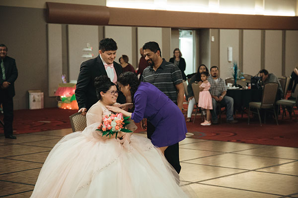 A mother presenting her daughter with a traditional gift during the former Mis Quince program that was hosted by MSC CAMAC.
