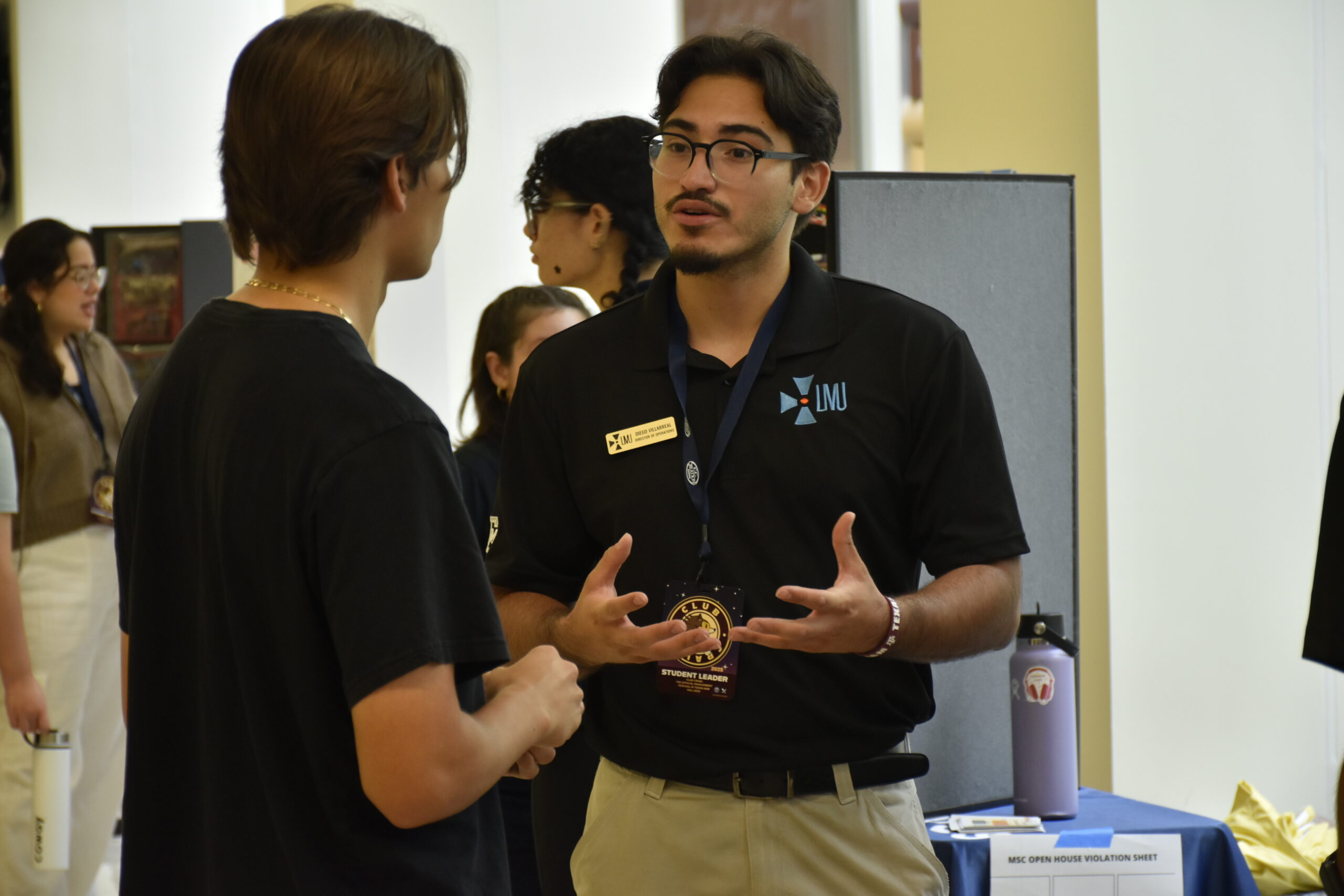 A member of Latino Males United recruiting a new member during Club Crawl.
